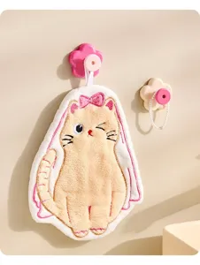 Close-up of a cute cat hanging hand towel displayed on a decorative flower wall hook.