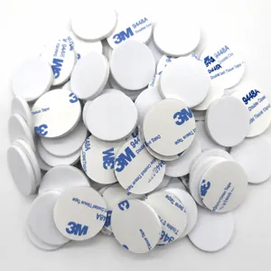 Close-up of circular double-sided adhesive pads with 3M 9448A backing