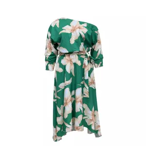 Detail view of plus size floral one-shoulder green dress featuring elegant wrap belt and soft fabric.