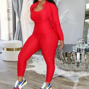 Women's 3-piece red honeycomb yoga set with long sleeve jacket, crop top, and active leggings.