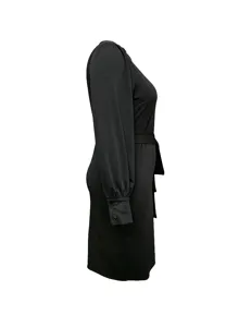 Side view of a black long-sleeve belted dress, highlighting the slim fit and cuff details.