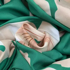 Detailed close-up view of the vibrant green and pink printed fabric texture and pattern design.