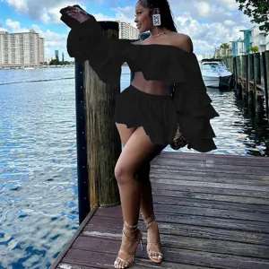 Black off-shoulder ruffle crop top and mini skirt two-piece set fine detail showcase.
