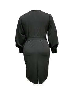 Black plus-size long-sleeve dress detail, showing back waist belt and hem slit design.