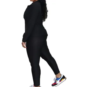 Close-up detail view of the black textured long sleeve athletic jacket and yoga pants set.
