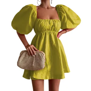 Square neck puff sleeve yellow mini dress detail, elegant summer fashion design close-up view.