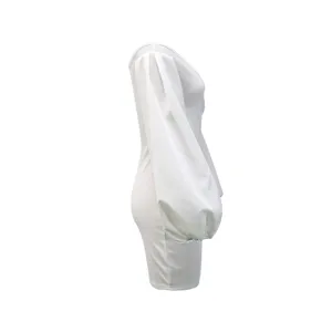 Side view detail of white bodycon dress featuring dramatic puff sleeves and slim fit.