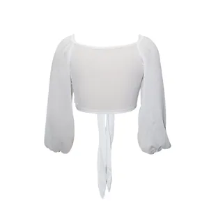 Detail of white long sleeve crop top with tie front, elegant casual summer top design details.