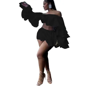 Detail view of the elegant black off-shoulder ruffles crop top and mini skirt two-piece set.