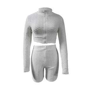 Detail shot of white honeycomb textured activewear long sleeve top and shorts active set.