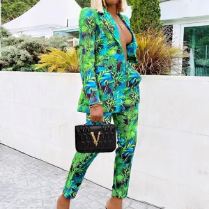 Detail view of the stylish green and blue tropical print women's pantsuit with blazer and trousers.
