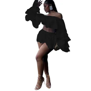 Detailed view of the black fashion ruffle off-shoulder crop top and matching mini skirt set.