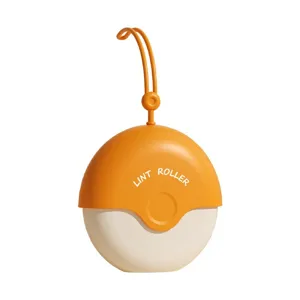 Portable mini lint roller for clothes and pet hair removal, capsule design with hanging strap.