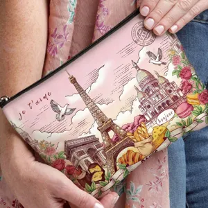 Close-up detail of vintage Paris oil painting print on a stylish cosmetic clutch bag.