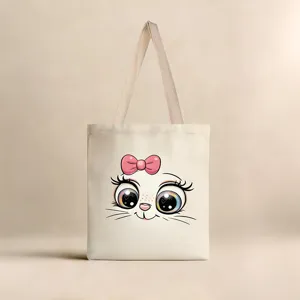Vista detallada de una bolsa de lona crema con un lindo estampado de cara de gato.
