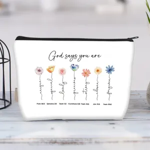 Detail of canvas makeup pouch featuring watercolor flowers and motivational quotes
