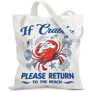 Close-up of a white canvas tote bag with a red crab and nautical themed print.