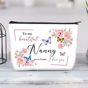 Detailed view of floral canvas makeup bag featuring beautiful Nanny quote and butterfly design