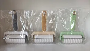 Lint roller detail view, portable color block sticky hair remover for clothes, sofa, and pet hair.
