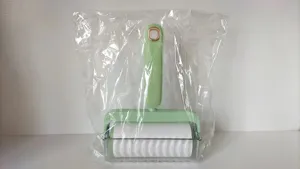 Portable lint roller for clothes and sofas, modern household pet hair sticky roller tool.