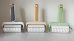 Modern minimalist color-blocked lint roller for clothes and sofas with transparent storage base.