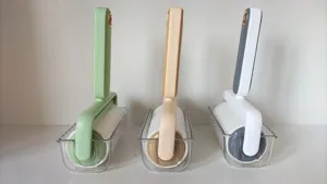 Detailed view of portable color-block lint roller with clear storage base for daily home use.