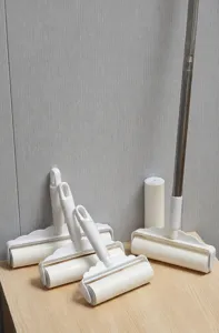 Detailed view of telescopic lint roller with adjustable handles and refill rolls for home cleaning.