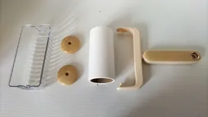 Detailed view of lint roller components, including transparent case, paper core and handle.