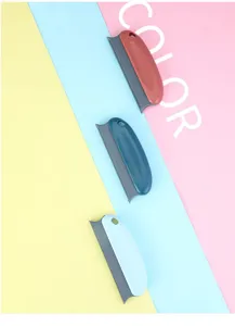 Detail view of portable pet hair remover tools in three colors with dense scraping edges.