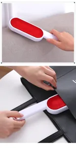 Detailed view of the double-sided lint remover brush being used effectively on fabric surfaces.