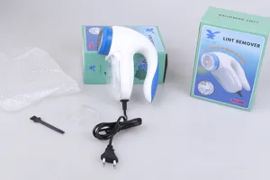 Plug-in electric lint remover for clothes with cleaning brush, protective cover and box.