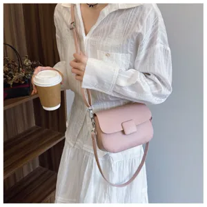 Stylish pink retro flap crossbody bag for women shown in a lifestyle street setting