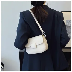 Detailed view of a vintage white flap crossbody bag with elegant textured finish and square clasp