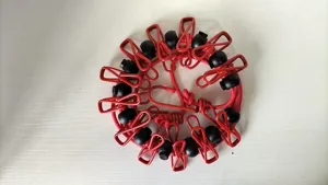 Portable elastic travel clothesline detail showing red rope and adjustable clips for drying.
