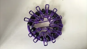 Close-up of portable elastic clothesline showcasing sturdy purple clips and fixed positioning beads.