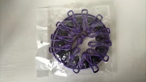 Purple elastic travel clothesline with windproof clips and beads for outdoor drying.