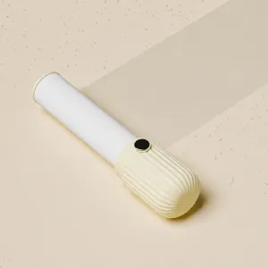 Portable lint roller, mini hair removal brush for clothes and pet hair, light yellow design.