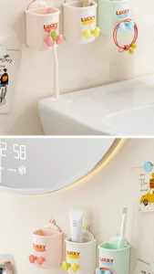 Detail shot of wall-mounted toothbrush holder, punch-free cup rack in pastel colors for bathroom.