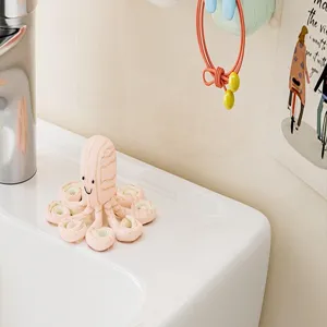 Bathroom toothbrush holder detail view showing wall mounted rack and cute octopus item.