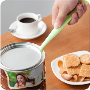 Multi-functional can opener and crevice cleaning scraper tool for kitchen use. Green color.