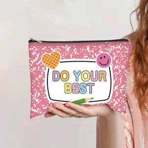 Detail of pink canvas pouch with 'DO YOUR BEST' print and cartoon stickers held in hand.