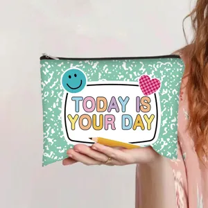 Close-up of a hand holding a mint green canvas pouch with Today Is Your Day quote.