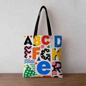 Detailed view of the vibrant geometric alphabet print on a thick canvas tote bag.