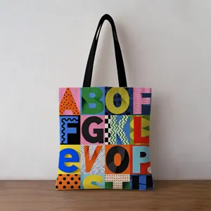 Close-up detail of a canvas tote bag featuring a vibrant geometric alphabet pattern