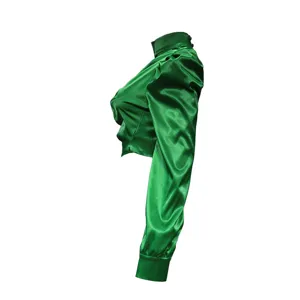 Close-up detail of the green satin high-collar crop top showcasing sleeve texture.