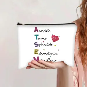 Canvas zipper pouch with ATSEM French inspirational words held by a person in hand