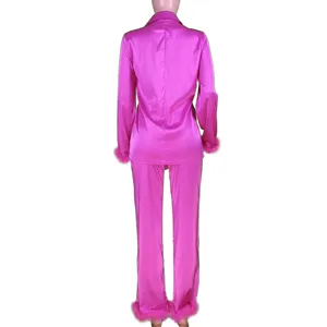 Back view detail of pink satin pajama set featuring lapel collar and plush cuffs.