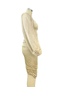 Side view detail of champagne satin ruched long sleeve dress showing exquisite texture and fit.