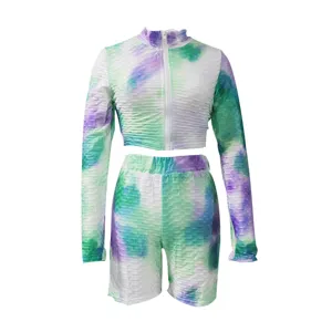 Tie-dye long sleeve zip crop top and matching shorts activewear set detail view.