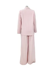 Pink blazer pantsuit back detail showing relaxed long sleeve fit and wide leg trousers fit.